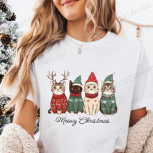Load image into Gallery viewer, Person wearing a white t-shirt with Christmas-themed cat graphics and 'Meowy Christmas' text.  Festive Feline Friends Tee - Crisp  White - JBCoolCats