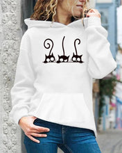 Load image into Gallery viewer, Person wearing a white hoodie with black cat illustrations Peeking Purrfection Kittie Hoodie - Frosty Furball White - JBCoolCats