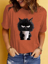 Load image into Gallery viewer, Person wearing a rusty t-shirt with a black cat holding a cup design