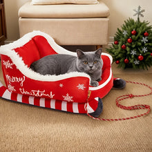 Load image into Gallery viewer, Gray cat in a red 'Merry Christmas' pet bed with a decorated tree in the background - Feline Express Sleigh Bed - Small - JBCoolCats