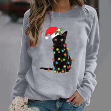 Load image into Gallery viewer, A person wearing a gray sweatshirt with a graphic of a black cat wearing a Santa hat and adorned with Christmas lights.  Twinkle Paws Christmas Cat Sweatshirt - Christmas - JBCoolCats