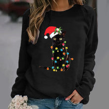 Load image into Gallery viewer, A person wearing a Black sweatshirt with a graphic of a black cat wearing a Santa hat and adorned with Christmas  lights. Twinkle Paws Christmas Cat Sweatshirt - Christmas - JBCoolCats