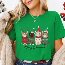 Load image into Gallery viewer, Person wearing a green t-shirt with Christmas-themed cat illustrations and 'Meowy Christmas' text. Festive Feline Friends Tee - Forest Green - JBCoolCats