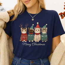 Load image into Gallery viewer, Person wearing a navy blue t-shirt with Christmas-themed cat illustrations and 'Meowy Christmas'  text - Festive Feline Friends Tee - Cozy Navy - JBCoolCatst