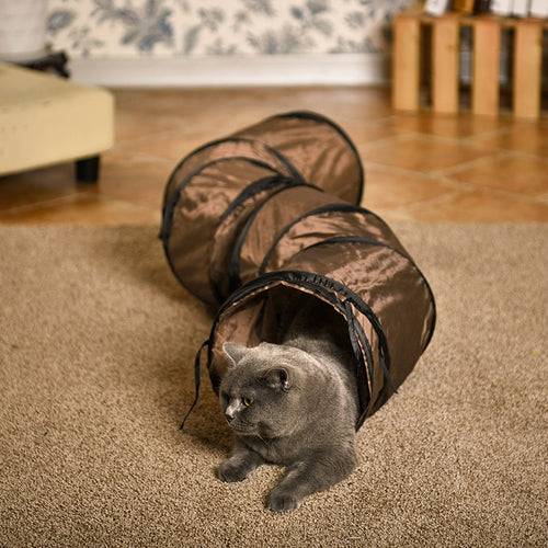 Cat playing with a brown tunnel on a carpeted floor  - Slinky Whiskers Cat Tunnel - Cat Toy - JBCoolCats