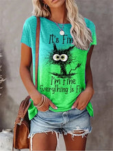 Load image into Gallery viewer, Person wearing a green t-shirt with a graphic and text, standing against a neutral background. I’m Fine… Totally Feline Tee - Clothing - JBCoolCats