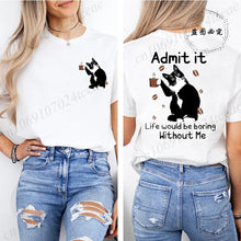 Load image into Gallery viewer, White t-shirt with a black cat graphic and text worn by a person, paired with ripped jeans. Paws &amp; Applause T-shirt - Soft Purr Mist - JBCoolCats
