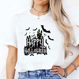 Person wearing a white t-shirt with a Halloween-themed design featuring a castle and bats. Happy Halloween' design - JBCoolCats