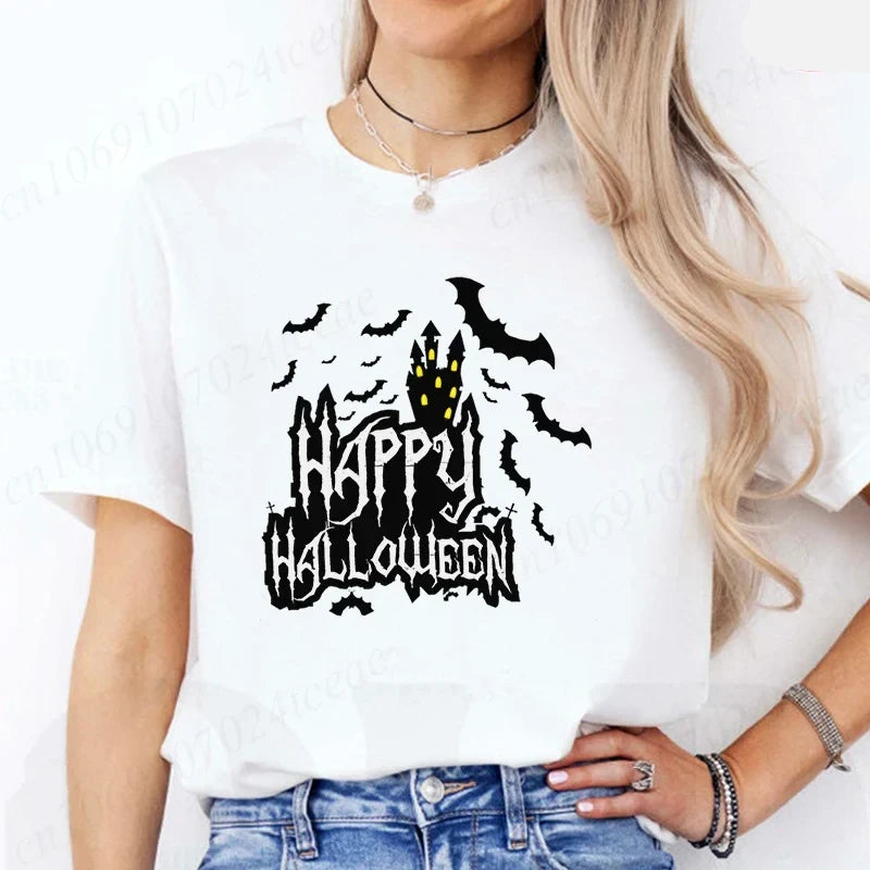 Person wearing a white t-shirt with a Halloween-themed design featuring a castle and bats. Happy Halloween' design - JBCoolCats