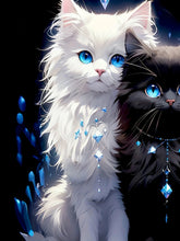 Load image into Gallery viewer, Illustration of a white and black cat with blue eyes and decorative elements. Crystal Purr‑fection Duo Tee - Closeup - JBCoolCats