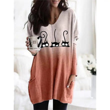 Load image into Gallery viewer, Woman wearing a orange and beige  tunic with black cat designs, - Three Cat Twilight Tunic - Sunset Meow gic - JBCoolCats 