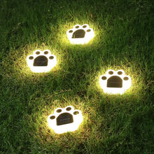 Load image into Gallery viewer, Solar lawn lights in the shape of cat paws, glowing in the dark, indicating they are illuminated. -Cat Paw Solar Lawn Lights - Accessory - JBCoolCats