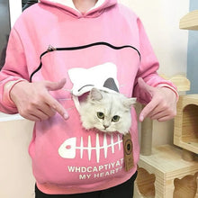 Load image into Gallery viewer, Person wearing a pink hoodie with a cat pouch, holding a white cat inside. Snuggle‑Me Pet Pouch Hoodie - Blush‑Me Pink - JBCoolCats 