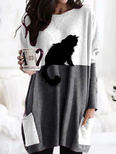 Load image into Gallery viewer, Person wearing a white and dark gray dress with a black cat design, holding a mug.   - JBCoolCats