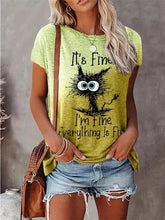 Load image into Gallery viewer, Person wearing a green t-shirt with a cat graphic and text, holding a brown bag. I’m Fine… Totally Feline Tee - Clothing - JBCoolCats