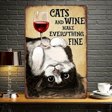 Load image into Gallery viewer, Vintage‑style metal wall art featuring a black and white cat lying upside down with a glass of red wine balanced on its belly, with the phrase “Cats and Wine Make Everything Fine -  Paws &amp; Pinot Metal Art Sign - Accessory - JBCoolCats