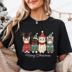 Person wearing a black t-shirt with Christmas-themed cat graphics and 'Meowy Christmas' text. Festive Feline Friends Tee - Clasic Black - JBCoolCats